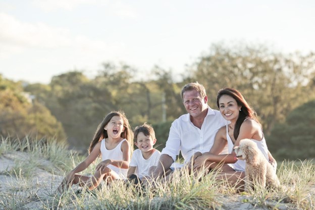 Happy family together in a field of grass