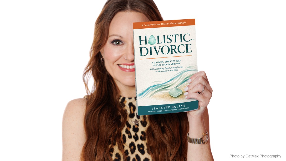 Jeanette Soltys holding her book Holistic Divorce